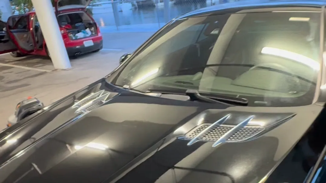 A car finished by TNT Auto Detailing, washed and polished at a covered garage in Miami
